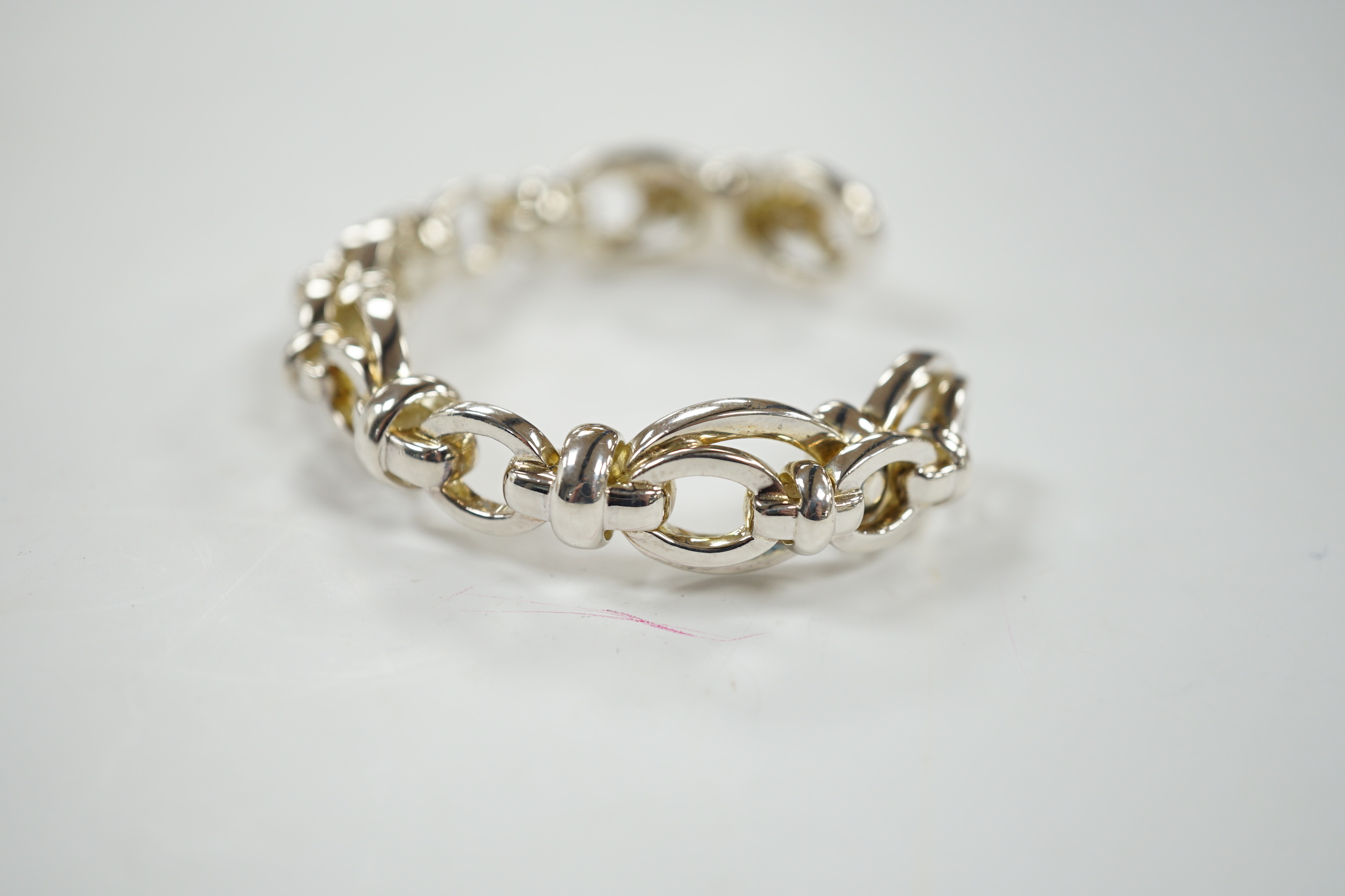 A modern Links of London silver oval link open work bangle, 60 grams, in Links of London box.